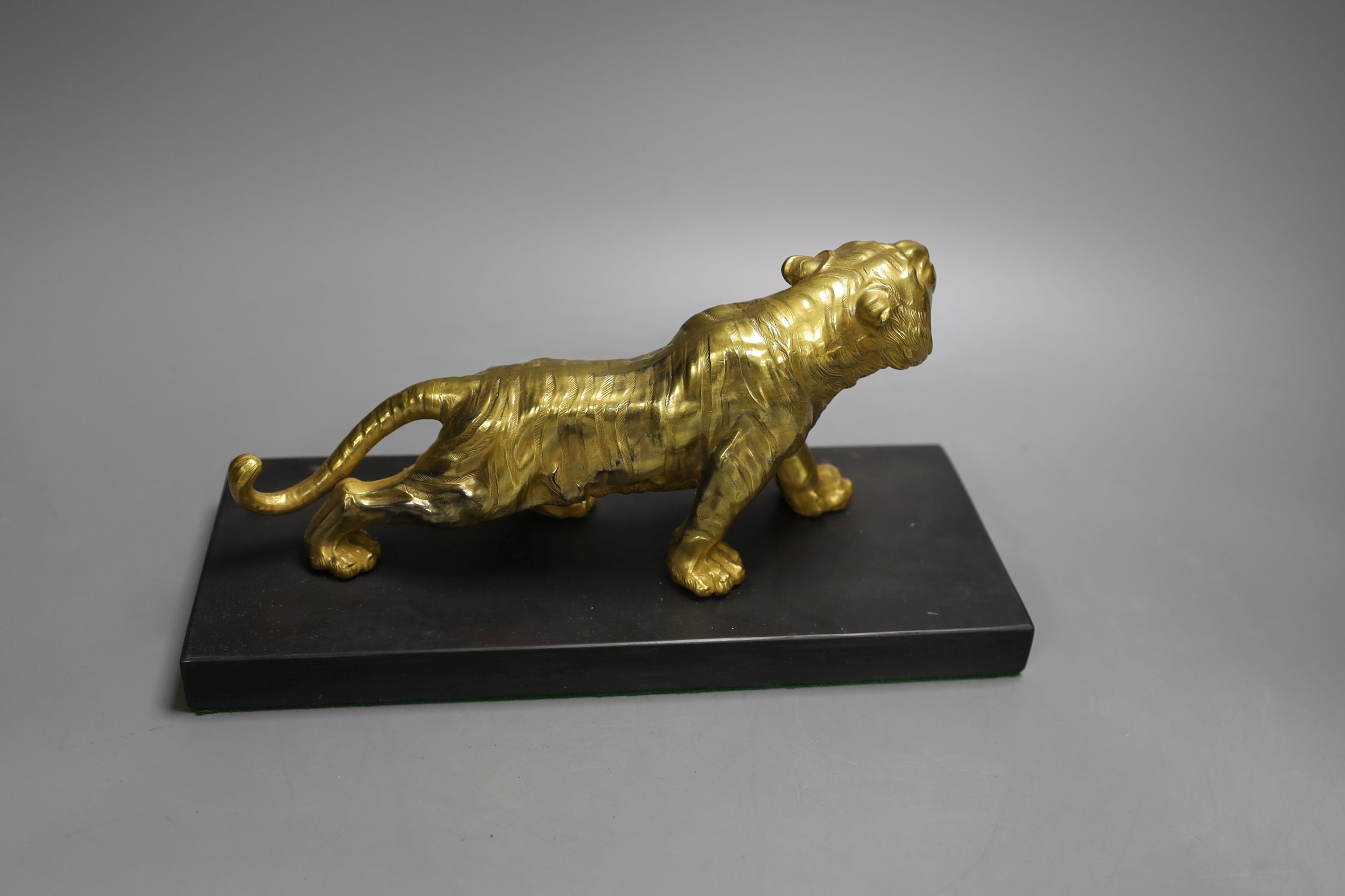 A gilt bronze figure of a tiger on base - 13cm tall